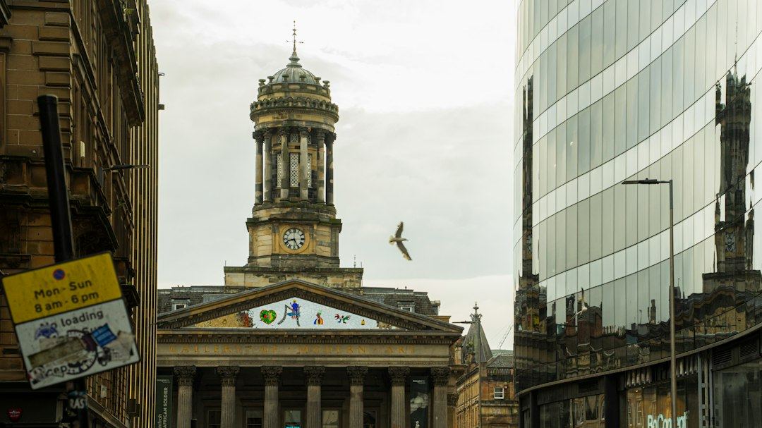 Ornate domed building and modern glass skyscraper in city